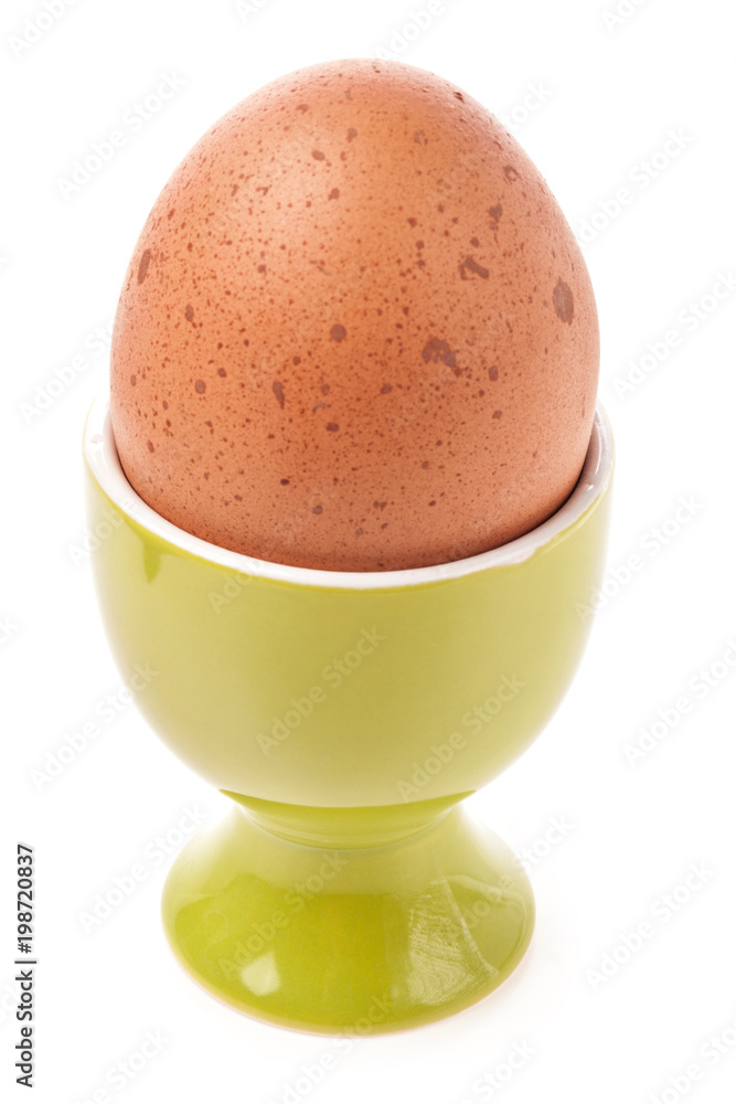 Egg in egg cup isolated on white Egg in egg cup isolated on white