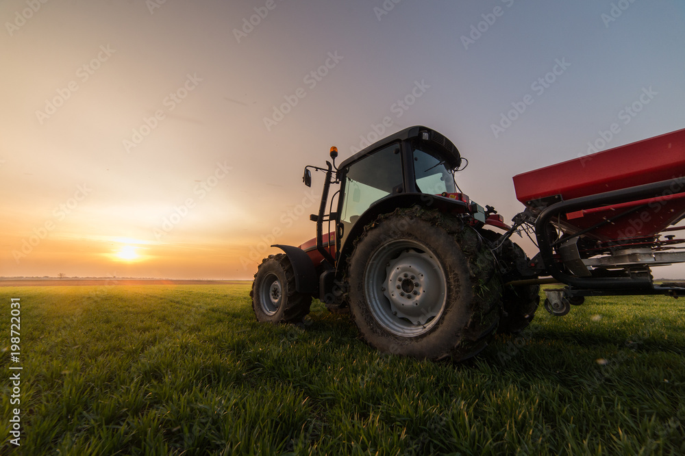 Farmer with tractor seeding - sowing crops at agricultural fields Farmer with tractor seeding - sowing crops at agricultural fields