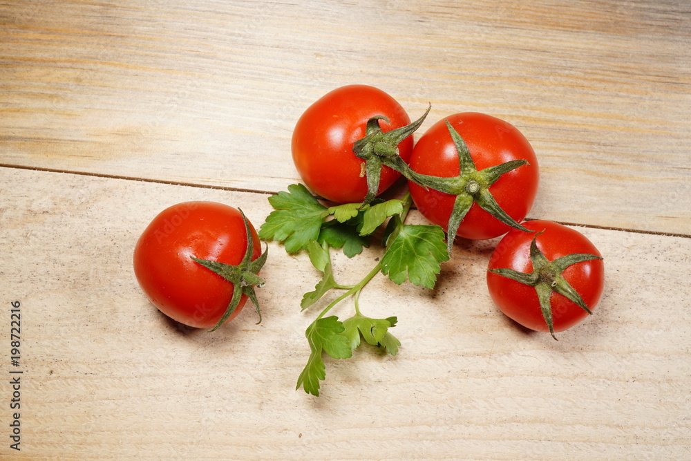Tomatoes and parsley on the wood table. Tomatoes and parsley on the wood table.