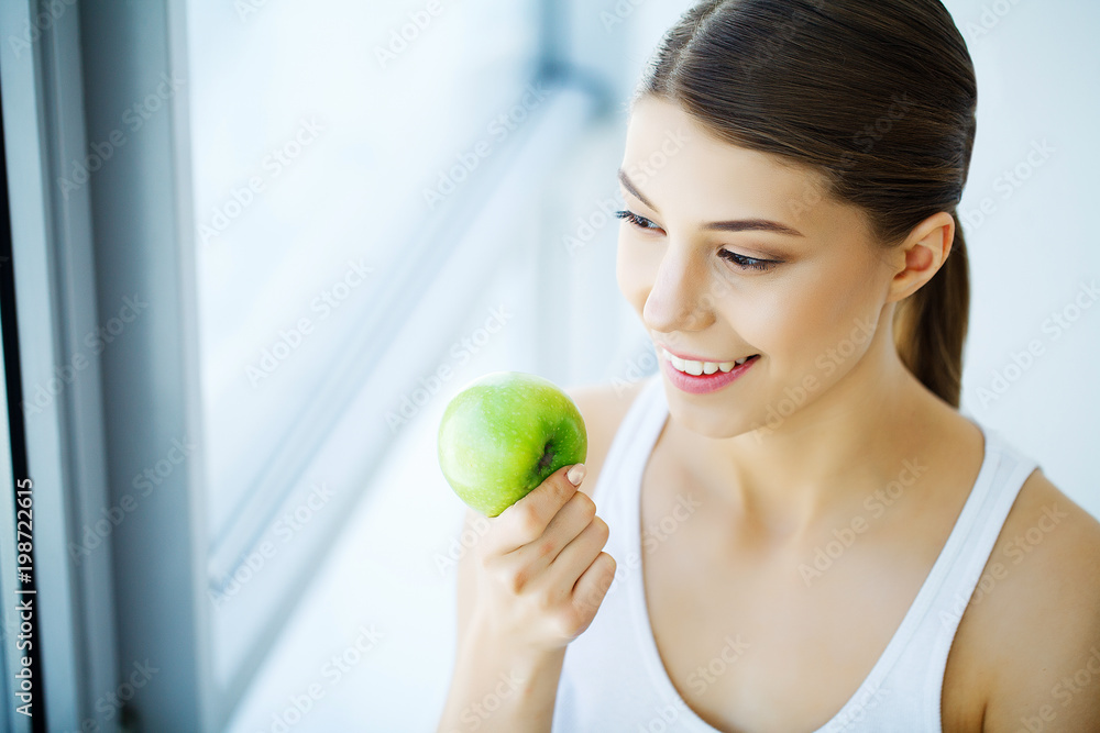 Smiling Woman With Beautiful Smile, White Teeth Holding Apple. High Resolution Image Smiling Woman With Beautiful Smile, White Teeth Holding Apple. High Resolution Image