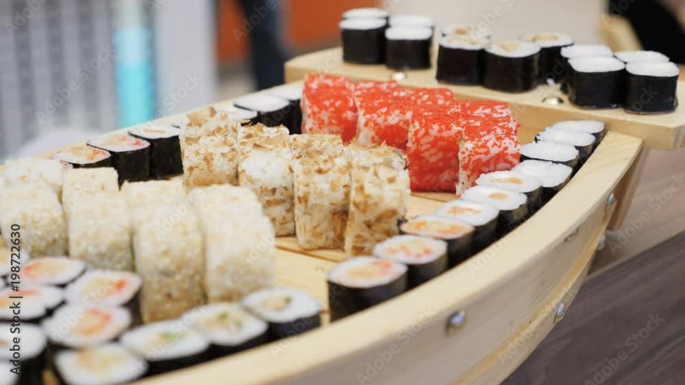 Sushi Rolls with Salmon Grig Served on Wood Tray Sushi Rolls with Salmon Grig Served on Wood Tray
