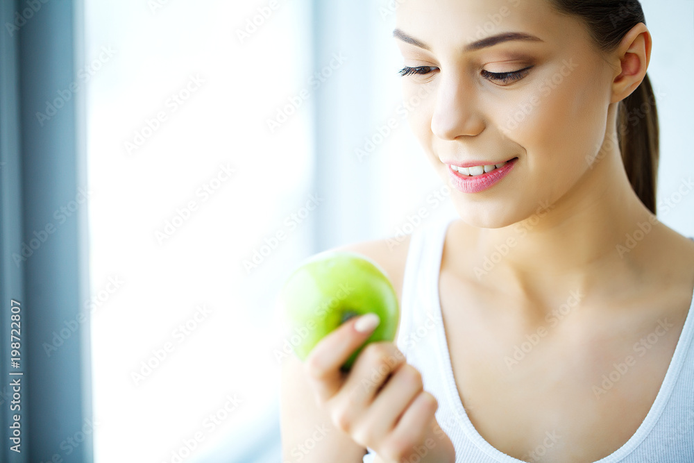 Smiling Woman With Beautiful Smile, White Teeth Holding Apple. High Resolution Image Smiling Woman With Beautiful Smile, White Teeth Holding Apple. High Resolution Image