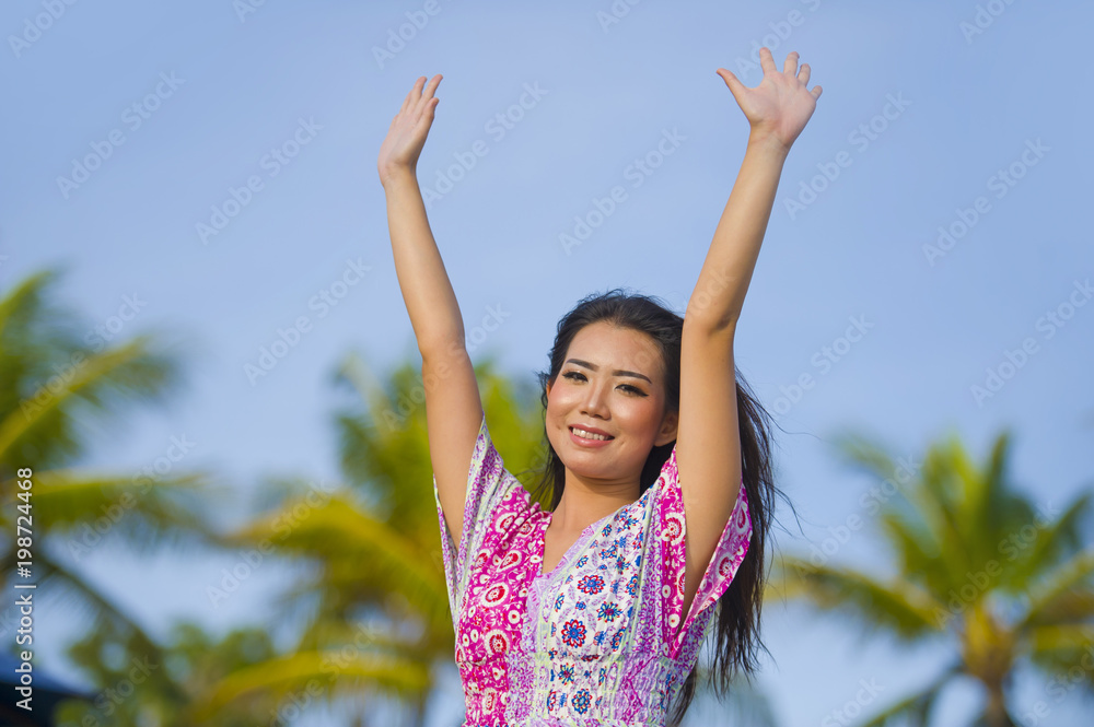 young happy beautiful Asian Chinese tourist woman smiling relaxed wearing sweet dress walking rising arms free at tropical resort on holidays trip enjoying in travel destination concept young happy beautiful Asian Chinese tourist woman smiling relaxed wearing sweet dress walking rising arms free at tropical resort on holidays trip enjoying in travel destination concept