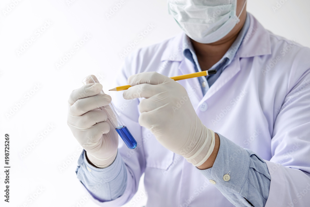 Scientist or medical in lab coat working in biotechnological laboratory equipment for research with mixing reagents in glass flask in clinical laboratory Scientist or medical in lab coat working in biotechnological laboratory equipment for research with mixing reagents in glass flask in clinical laboratory