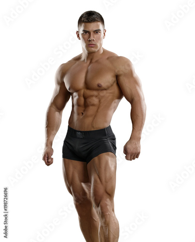 Valokuva Muscular tanned man in a beautiful pose on a white background
