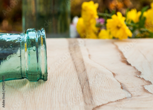 beautiful background, throat from bottle in the foreground, background yellow flowers photo