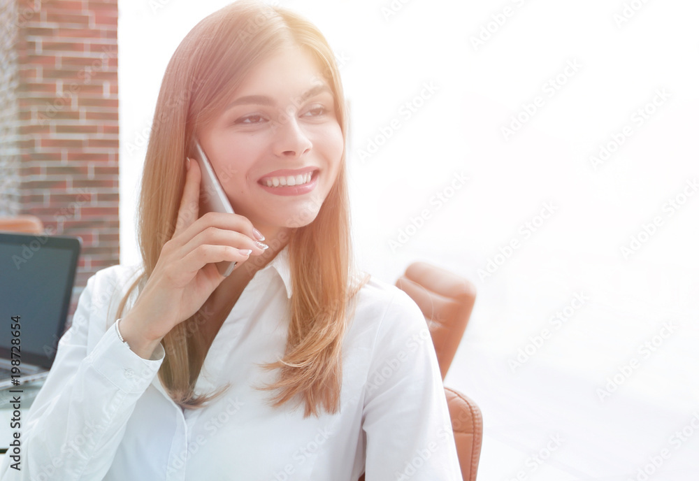 closeup.female assistant talking on mobile phone in office closeup.female assistant talking on mobile phone in office