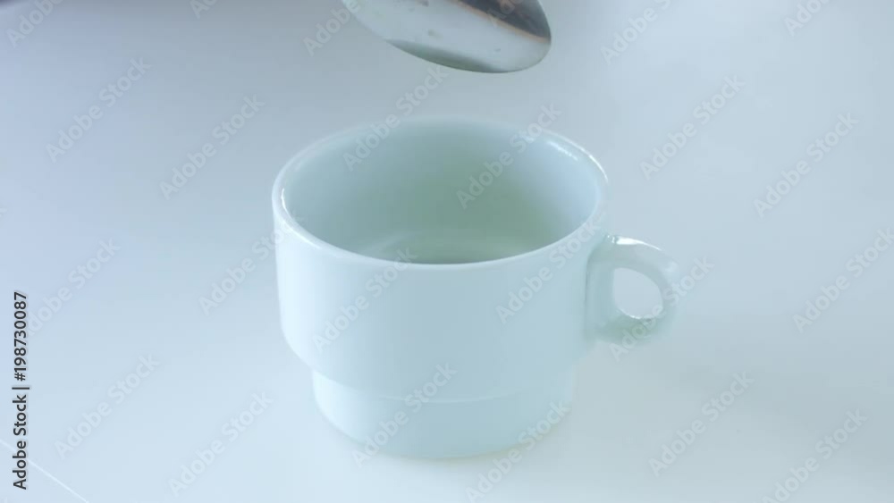 slow motion of matcha tee powder falling in white cup slow motion of matcha tee powder falling in white cup