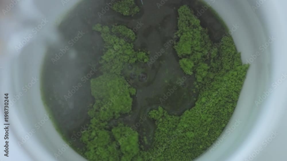 top view of cup with matcha tee preparation process top view of cup with matcha tee preparation process