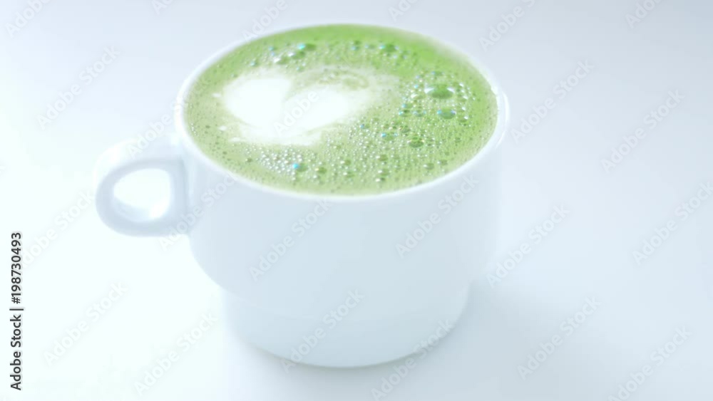 man put a cup with matcha latte toward a camera closeup man put a cup with matcha latte toward a camera closeup