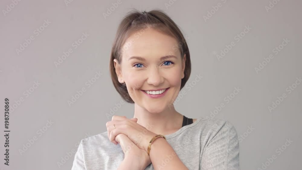 happy smiling woman on grey Wondering and smiling woman happy smiling woman on grey Wondering and smiling woman