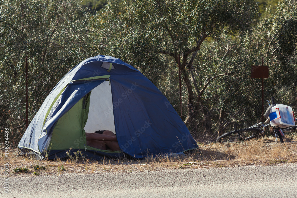 tourist tent near the road on the roadway. Tourist camping in Greece