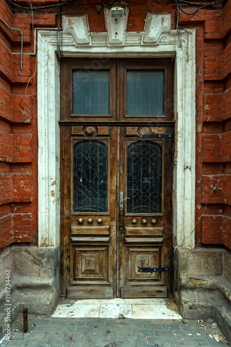 Old vintage wooden door with glass and metal parts