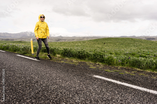 Woman walking funny down a road