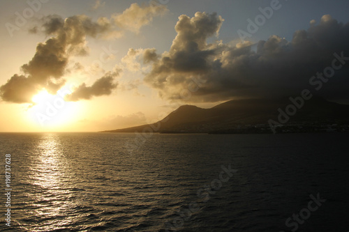 Sunset over the island of St Kitts, with beautiful reflections on the ocean, Caribbean.