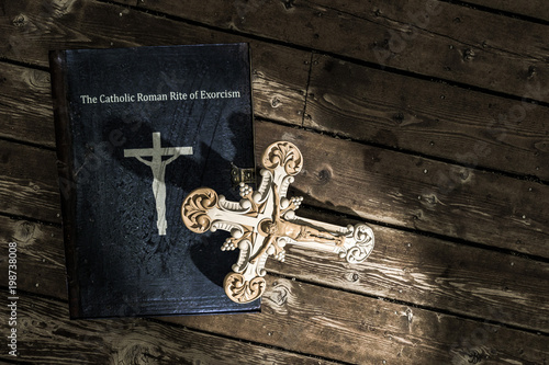 exorcism book on wooden floor photo