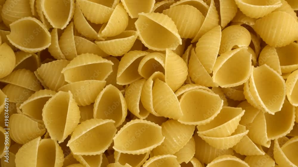 Raw conchiglie rigate closeup revolving on a turntable. Overhead view. Not loopable.