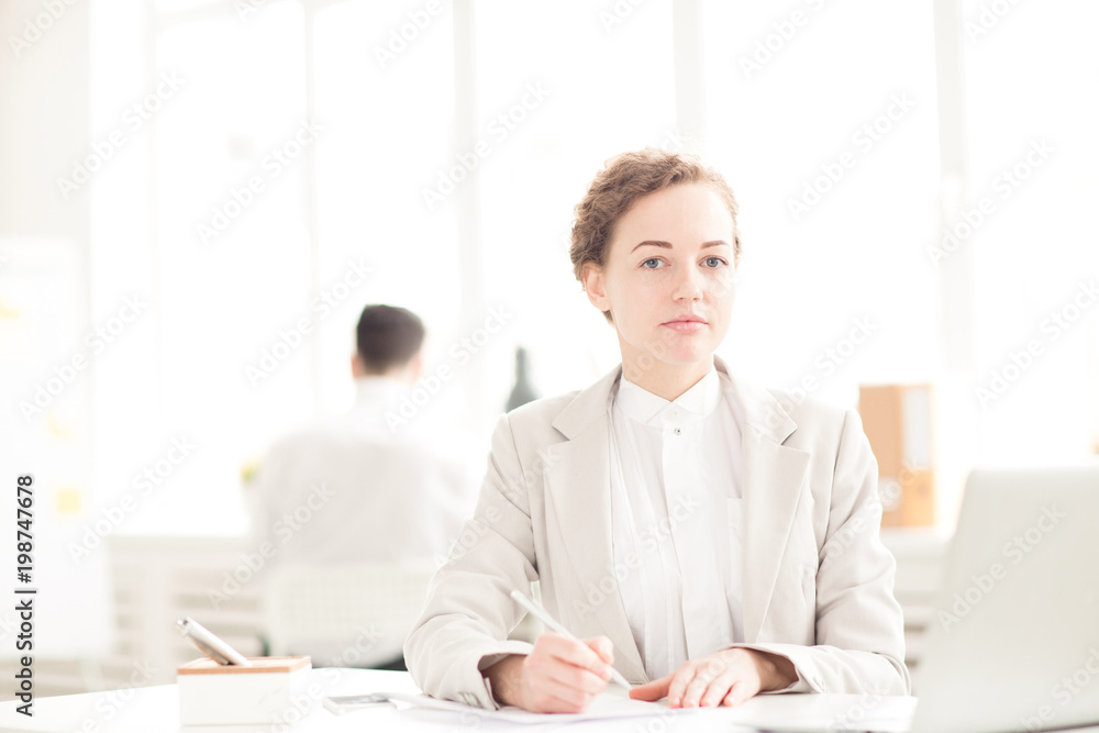 Portrait of young businesswoman working at her workplace at office Portrait of young businesswoman working at her workplace at office