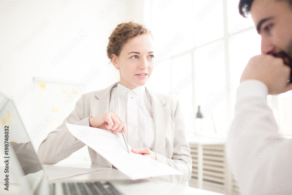 Businesswoman suggesting to sign a contract to her partner Businesswoman suggesting to sign a contract to her partner