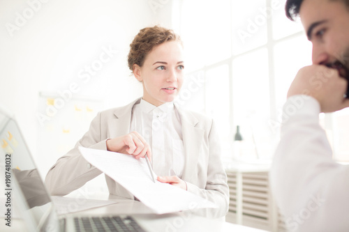 Businesswoman suggesting to sign a contract to her partner