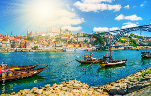 Dom Luis I bridge and traditional boats on Rio Douro river in Porto, Portugal