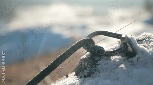 Climbing rope slides in a carabiner. Insurance climbers closeup.