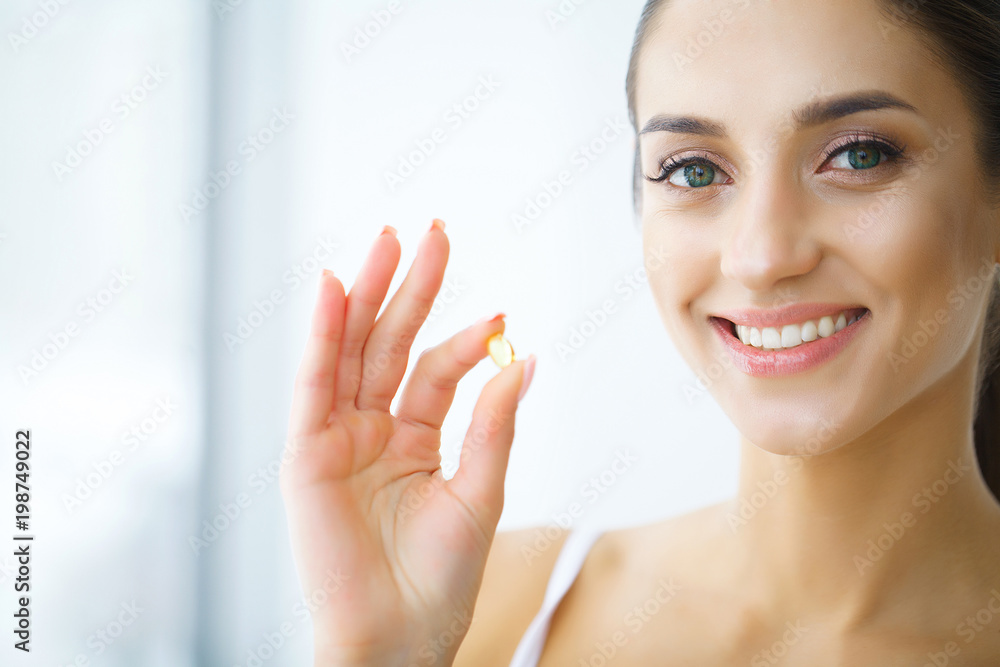 Nutrition. Healthy Lifestyle. Woman Holding Pill With Fish Oil Omega-3. Supplements, Vitamins. Nutrition. Healthy Lifestyle. Woman Holding Pill With Fish Oil Omega-3. Supplements, Vitamins.