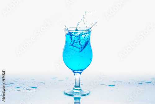 Glass and water splash in white background © songdech17
