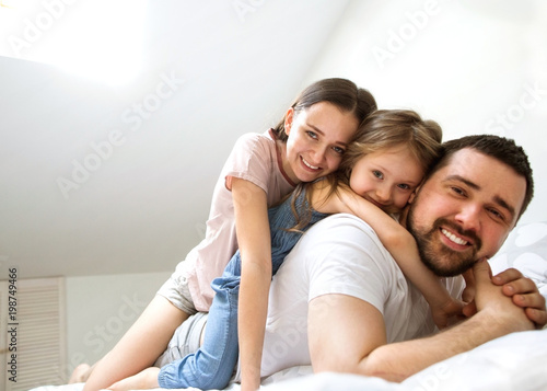family with daughter having fun at home, the concept of a happy family.