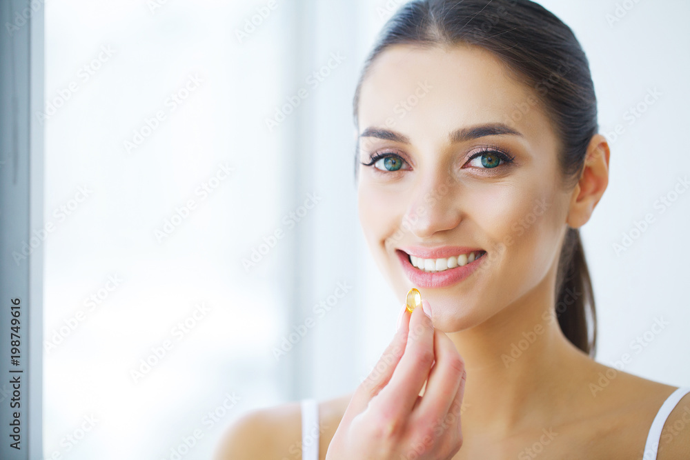 Nutrition. Healthy Lifestyle. Woman Holding Pill With Fish Oil Omega-3. Supplements, Vitamins. Nutrition. Healthy Lifestyle. Woman Holding Pill With Fish Oil Omega-3. Supplements, Vitamins.