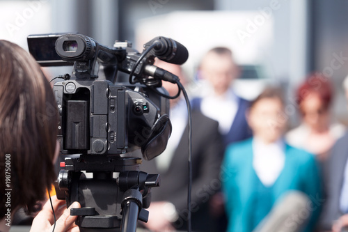 News conference. Filming an event with a video camera. Cameraman.