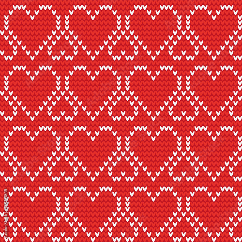 Knitted red white background of big and small hearts. To the day of Saint Valentine. For decoration, design, postcards, invitations, wallpapers, fabrics, knitting.