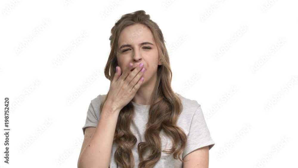 Portrait of tired exhausted woman being sleepy and yawning because of insomnia, isolated over white background. Concept of emotions Portrait of tired exhausted woman being sleepy and yawning because of insomnia, isolated over white background. Concept of emotions