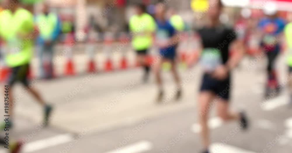 Blur view of athletes running for city marathon Blur view of athletes running for city marathon
