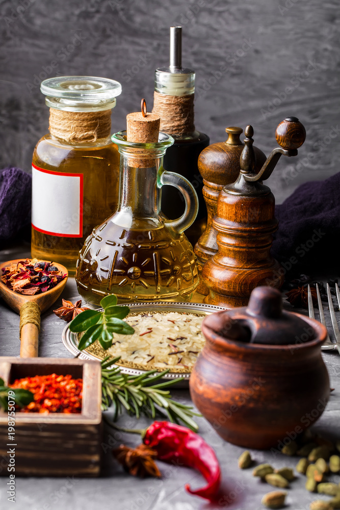 Spices for cooking with kitchen accessories on an old background Spices for cooking with kitchen accessories on an old background