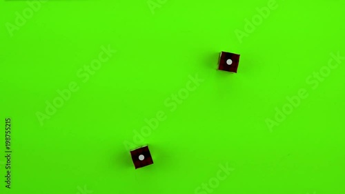 Red casino dice being rolled and settling on craps (double one) on a green screen. Multiple rolls