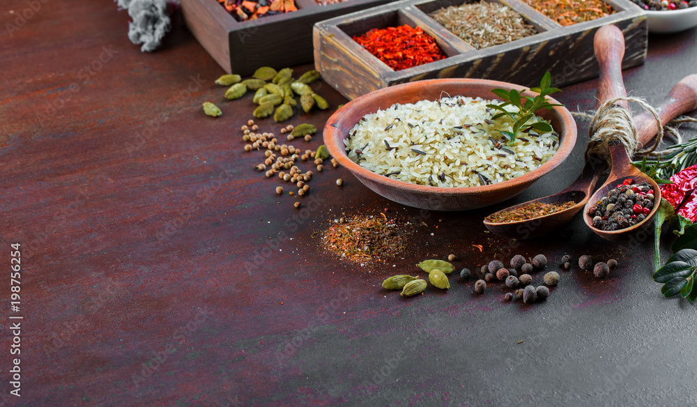 Spices for cooking with kitchen accessories on an old background Spices for cooking with kitchen accessories on an old background