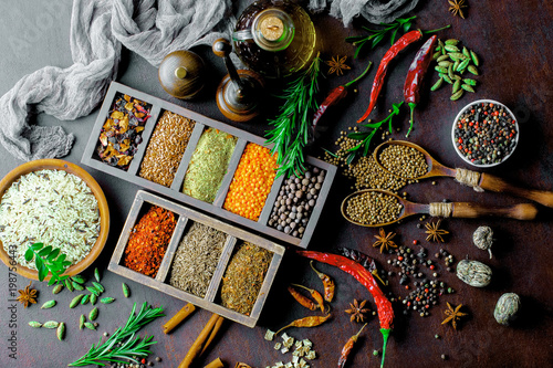 Fototapeta Naklejka Na Ścianę i Meble -  Spices for cooking with kitchen accessories on an old background