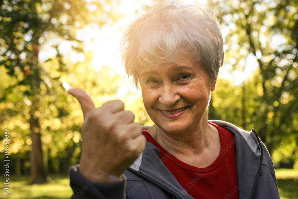 Cheerful senior woman showing OK. Looking at camera. Cheerful senior woman showing OK. Looking at camera.