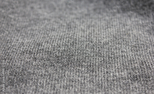 Gray Textured Background of Dark Grey Knit Sweater Close Up. Fashion Clothes Surface of Fabric Material Design. Empty Backdrop, Stylish Simple Pattern. Urban Apparel Canvas for Copy Space Template.