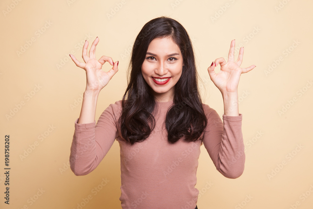 Asian woman show double OK hand sign and smile. Asian woman show double OK hand sign and smile.