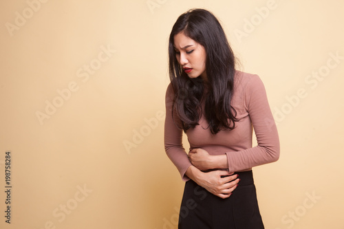 Bild auf Leinwand Young Asian woman got stomachache.
