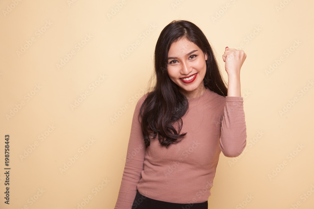 Successful young Asian woman hold fist up. Successful young Asian woman hold fist up.