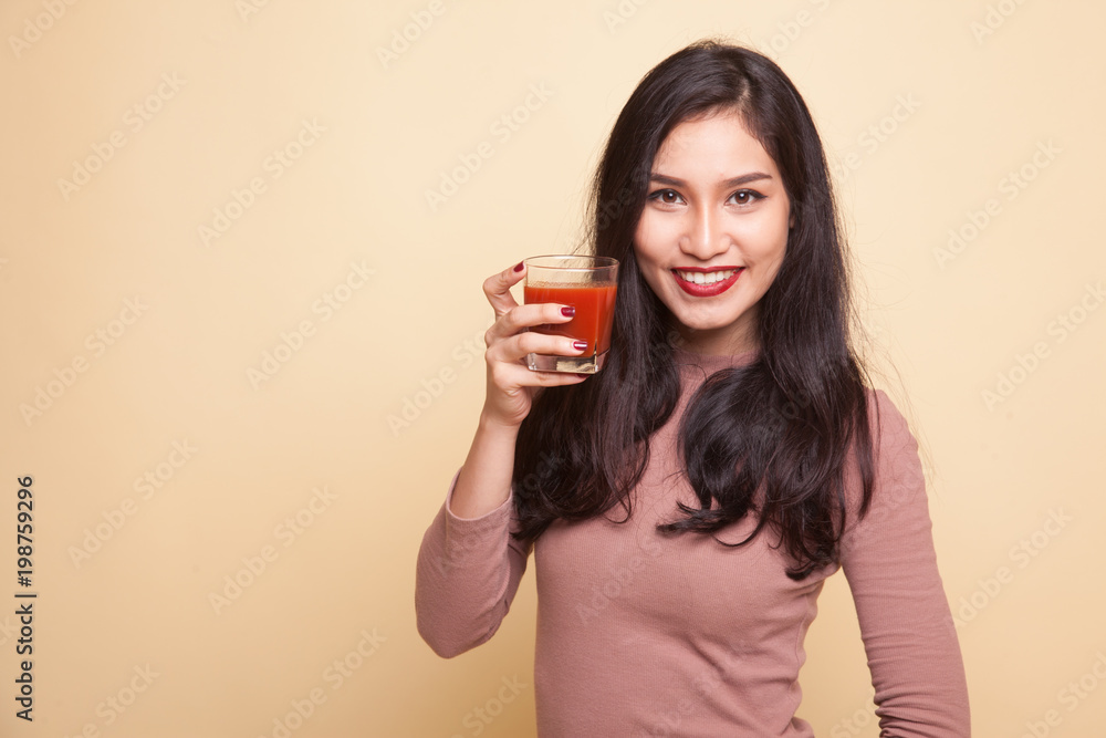 Asian woman with a clock drink orange juice. Asian woman with a clock drink orange juice.