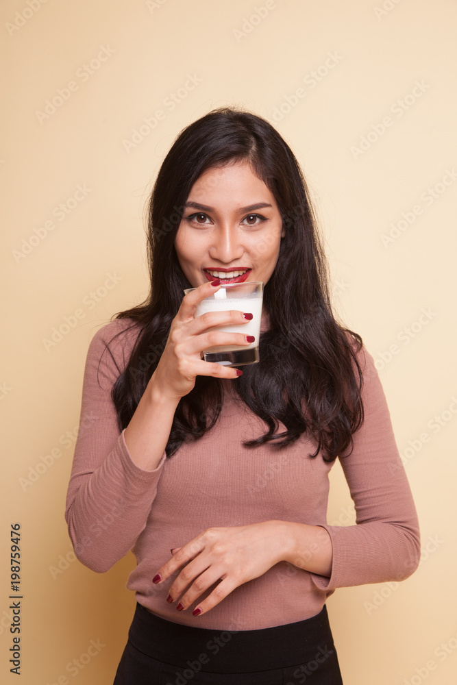 Young Asian woman thumbs up with a glass of drinking water. Young Asian woman thumbs up with a glass of drinking water.