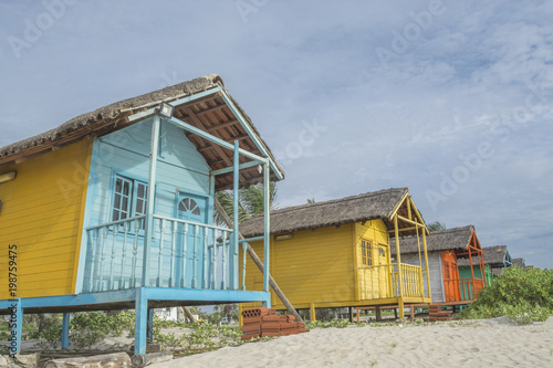 colored wood beach houses © Miguel Almeida