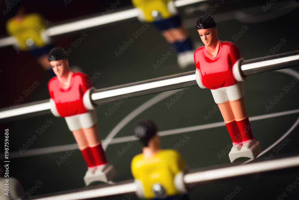 closeup of football figurine on foosball table soccer game
