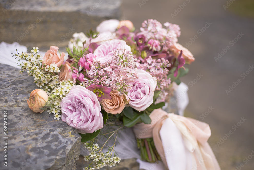Beautiful wedding bouquet on the rocks