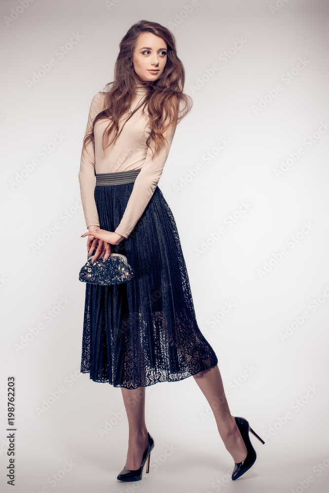 A studio portrait of a sexy hot lady in black skirt. A studio portrait of a sexy hot lady in black skirt.