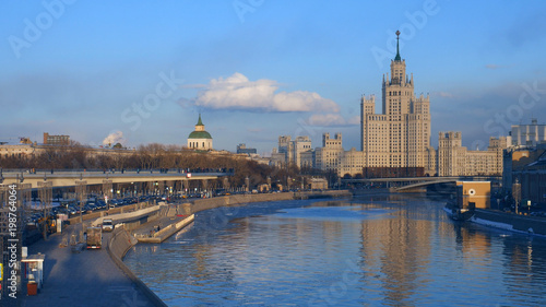 Floating bridge of "Zaryadye" park./Floating bridge of "Zaryadye" park and high-rise building on Moskvoretskaya Embankment of Moskva River in Moscow city, Russia.